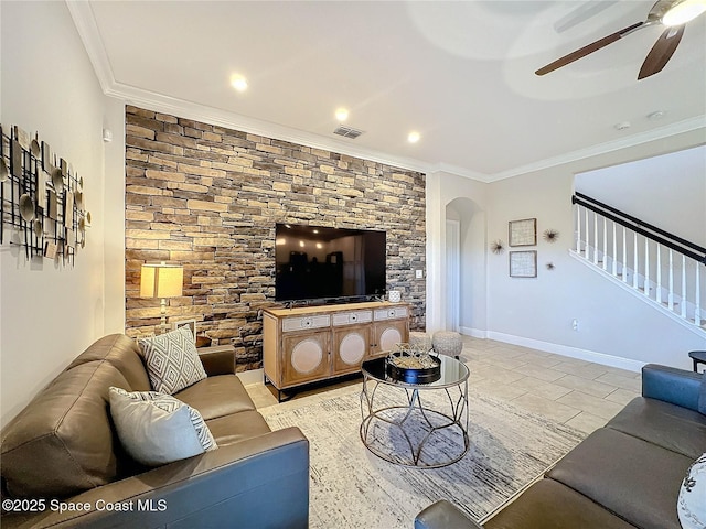 living area with visible vents, a ceiling fan, stairway, arched walkways, and crown molding