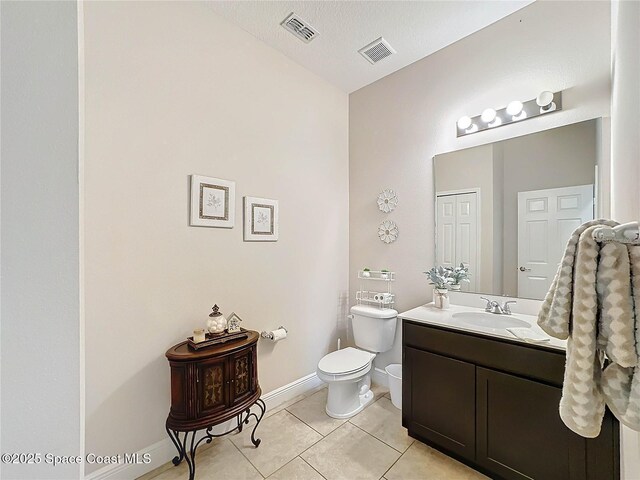 bathroom with tile patterned floors, visible vents, toilet, and vanity