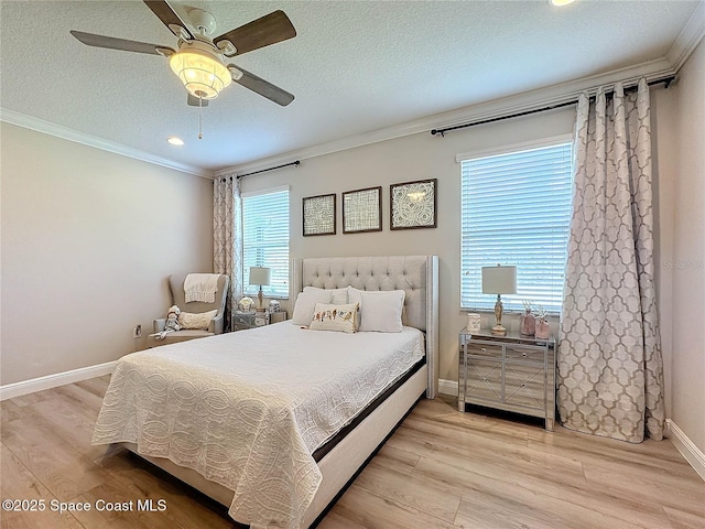 bedroom with baseboards, ceiling fan, ornamental molding, a textured ceiling, and light wood-type flooring