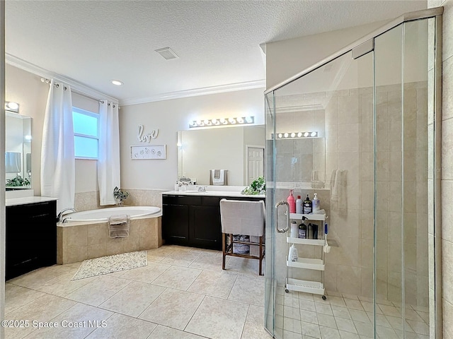 bathroom featuring a shower stall, crown molding, vanity, a garden tub, and a textured ceiling