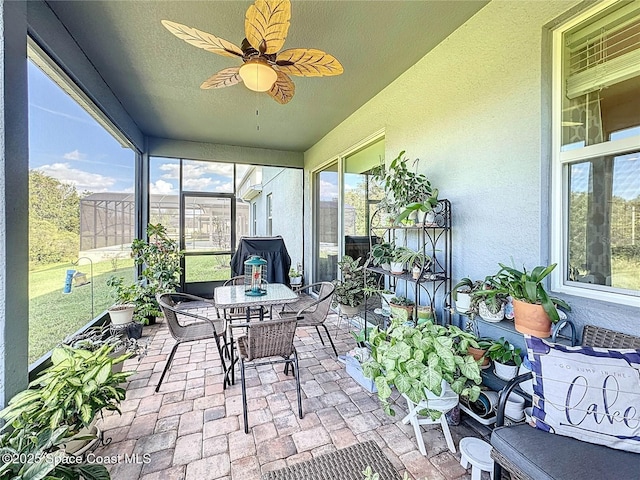 sunroom / solarium with a ceiling fan