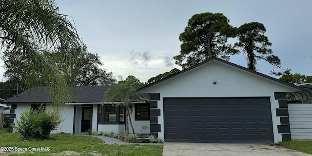 single story home featuring a shingled roof, a garage, driveway, and stucco siding