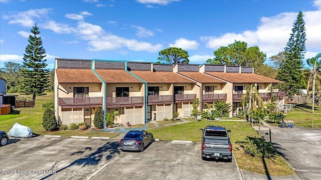 view of property featuring uncovered parking