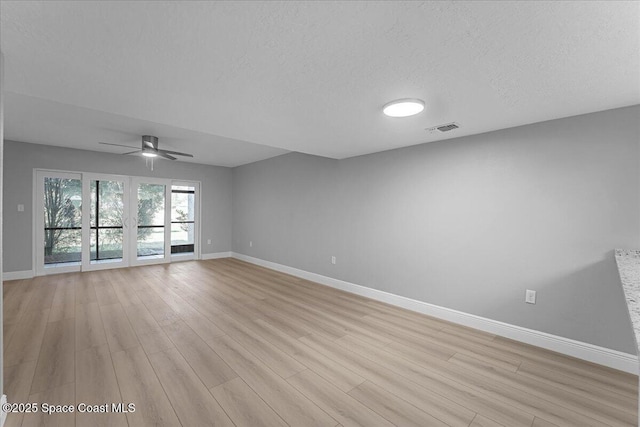 spare room with a ceiling fan, baseboards, visible vents, and light wood-type flooring