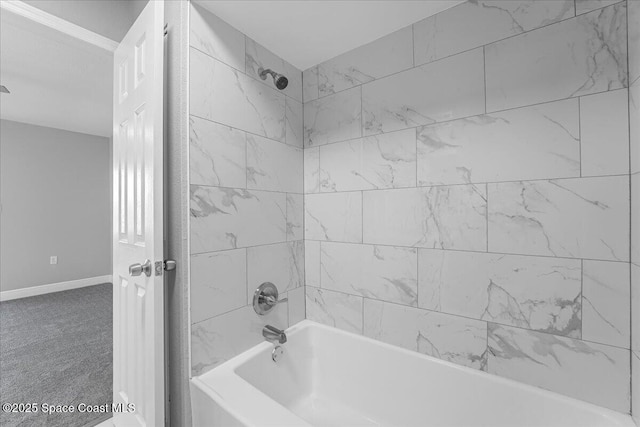 bathroom with baseboards and shower / bathtub combination