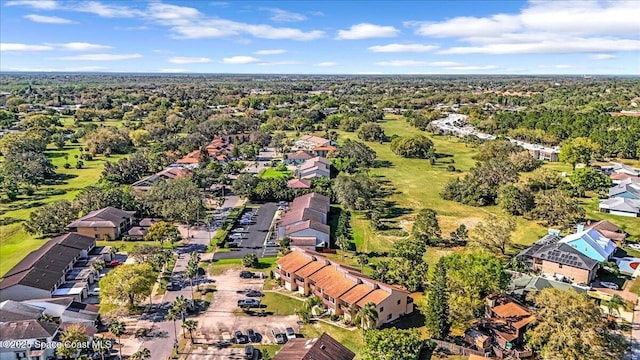 bird's eye view featuring a residential view and a wooded view