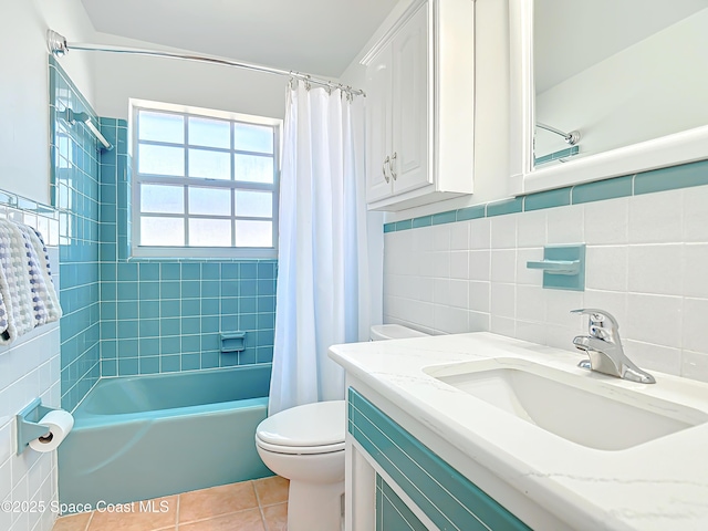 full bath with toilet, vanity, shower / bath combo, tile patterned floors, and tile walls