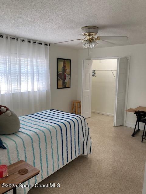 bedroom with baseboards, a textured ceiling, and a ceiling fan