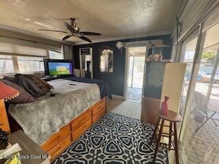 bedroom with ornamental molding, baseboards, and a textured ceiling