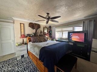 bedroom with ceiling fan and a textured ceiling