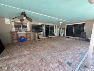 unfurnished living room with ceiling fan