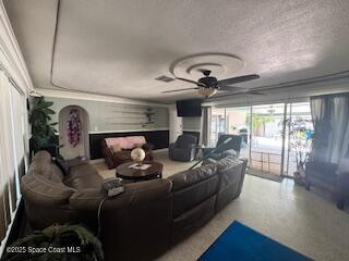 cinema room featuring ceiling fan, speckled floor, and a textured ceiling