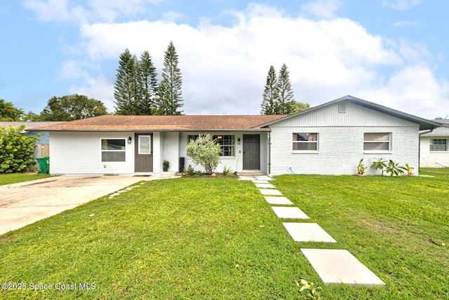 ranch-style house with brick siding, driveway, and a front lawn