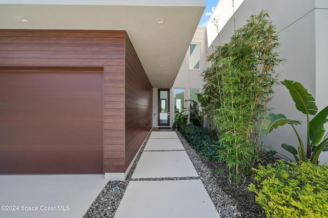 entrance to property featuring stucco siding