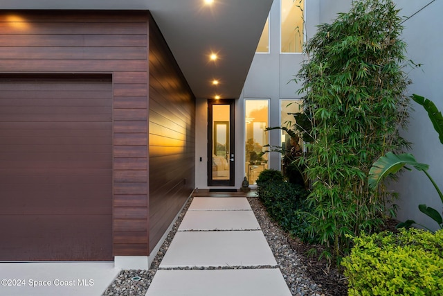 property entrance featuring an attached garage