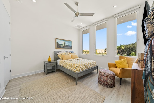 bedroom with visible vents, baseboards, light wood-style floors, and a ceiling fan