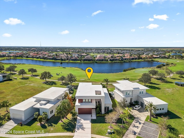 drone / aerial view with a residential view, a water view, and view of golf course