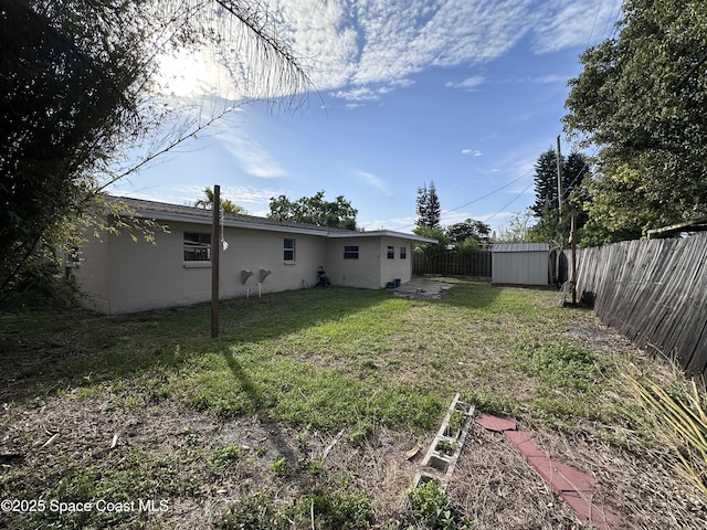 view of yard with an outbuilding and a fenced backyard