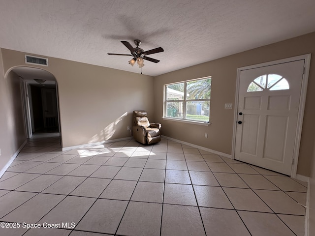 foyer with light tile patterned floors, visible vents, and a textured ceiling