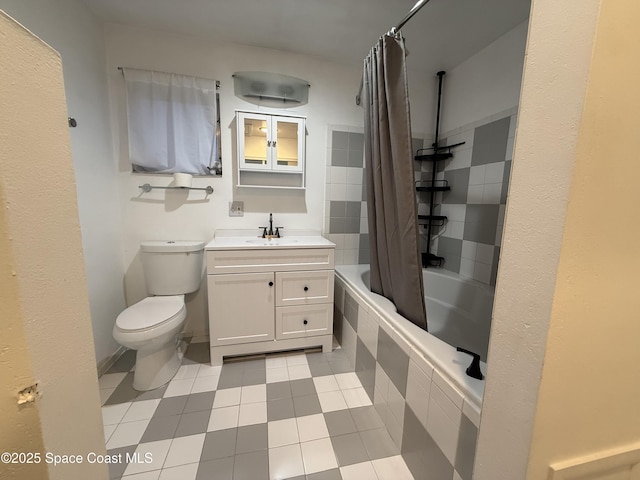 bathroom featuring toilet, vanity, and tiled shower / bath