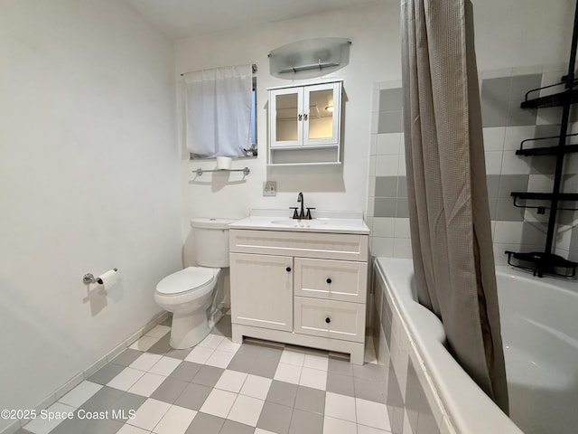 bathroom with baseboards, vanity, toilet, and shower / tub combo