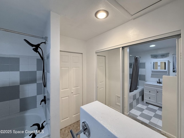 full bathroom featuring a closet, shower / bath combo with shower curtain, and vanity