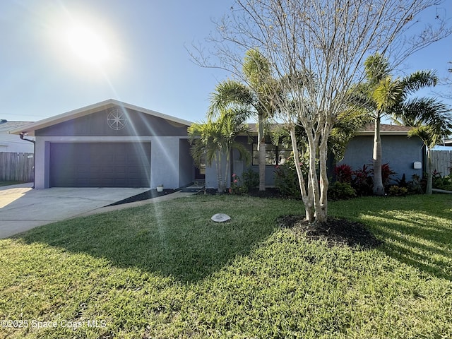 ranch-style home featuring fence, driveway, an attached garage, stucco siding, and a front lawn