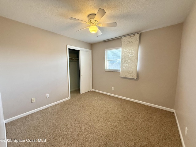 unfurnished bedroom featuring carpet flooring, a textured ceiling, and baseboards