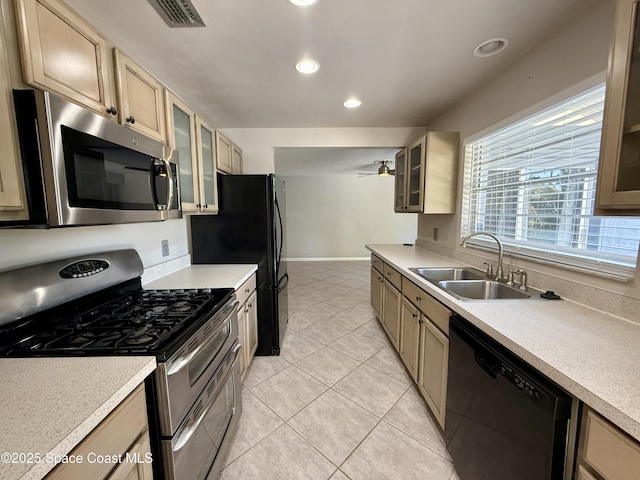 kitchen with visible vents, black appliances, a sink, light countertops, and light tile patterned floors