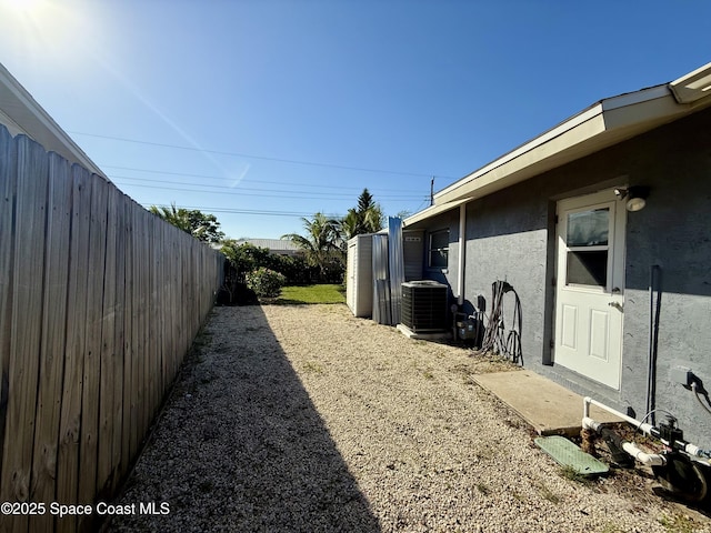 view of yard featuring cooling unit and fence