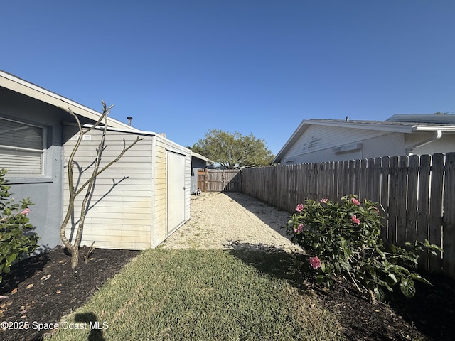 view of yard with an outdoor structure and a fenced backyard