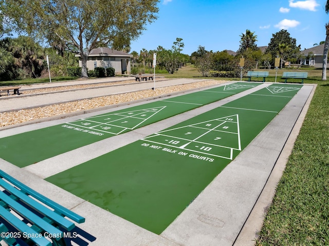 view of community featuring a yard and shuffleboard