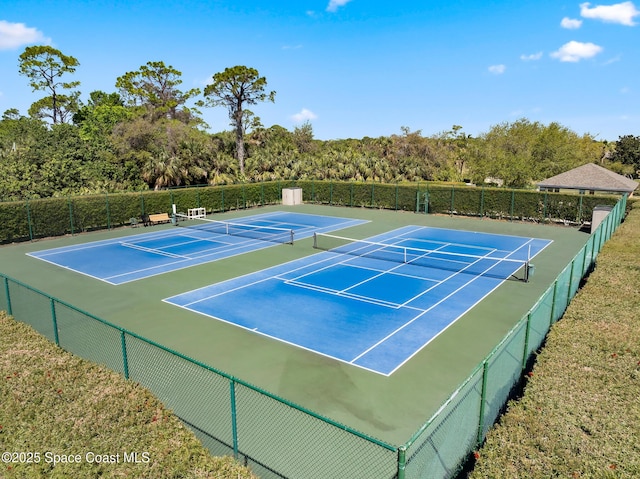 view of tennis court featuring fence