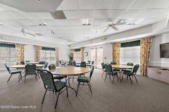 dining room featuring a drop ceiling, a healthy amount of sunlight, and ceiling fan