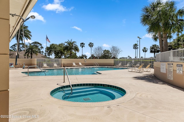 pool featuring a patio area, a hot tub, and fence