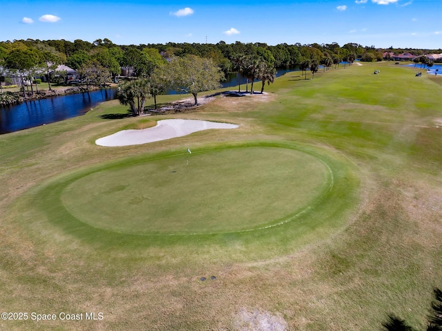 surrounding community featuring view of golf course and a water view