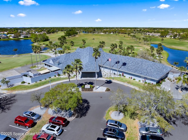 drone / aerial view featuring a water view and golf course view