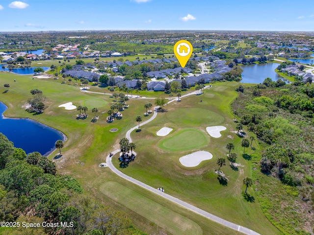 aerial view featuring golf course view and a water view