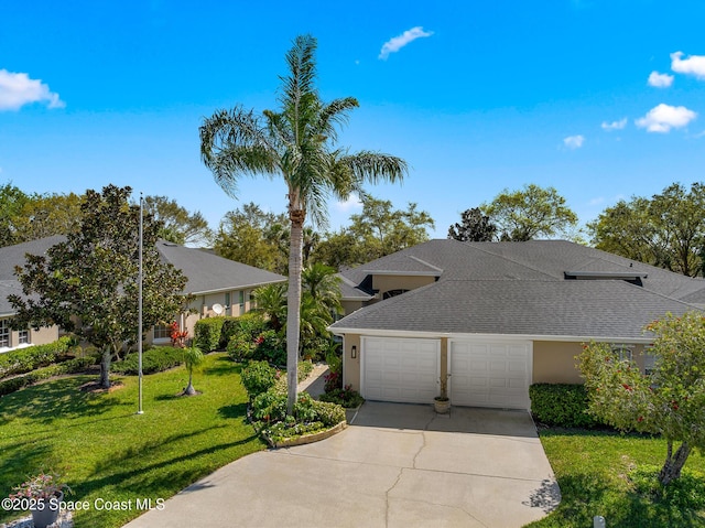 view of front of home with stucco siding, a front lawn, concrete driveway, a shingled roof, and a garage