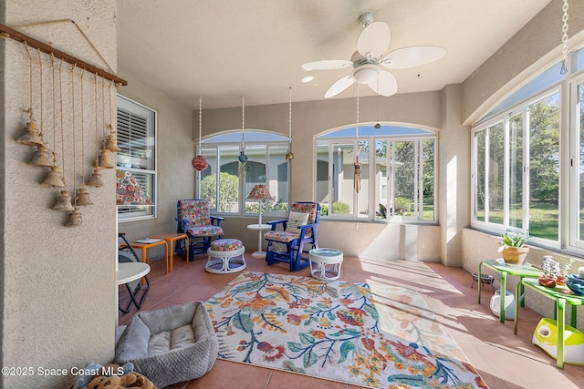 sunroom featuring plenty of natural light and ceiling fan