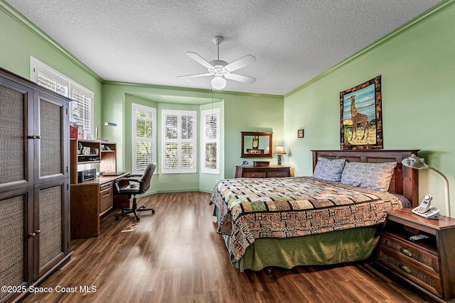 bedroom with a textured ceiling, crown molding, a ceiling fan, and wood finished floors