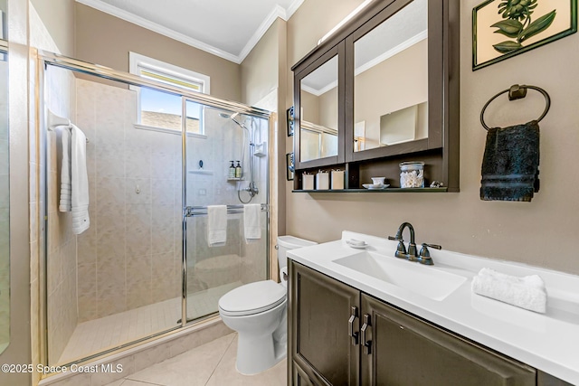 full bathroom featuring tile patterned flooring, a shower stall, crown molding, toilet, and vanity