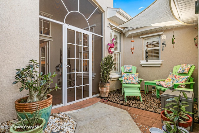 view of exterior entry featuring stucco siding