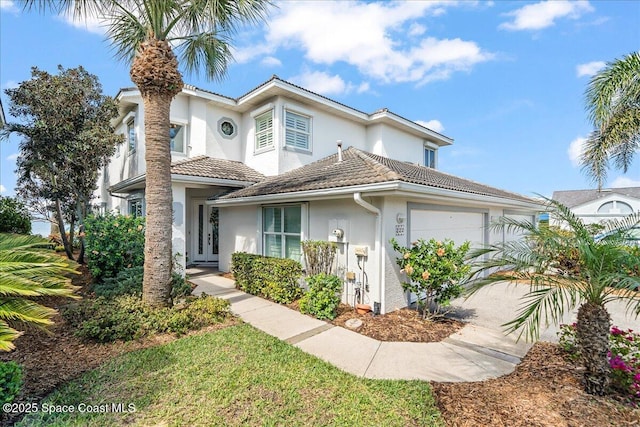 222 Glengarry Ave, Melbourne Beach, FL 32951 - view of front facade with a tile roof, stucco siding, and a garage