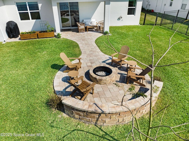 view of yard with a patio area, a fire pit, and fence