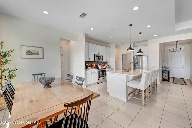 dining area with an inviting chandelier, light tile patterned flooring, recessed lighting, and visible vents