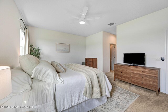 bedroom featuring visible vents, ceiling fan, and carpet