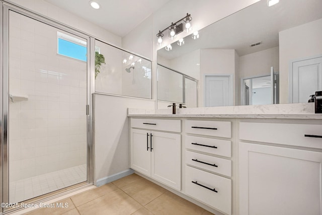 full bathroom featuring visible vents, vanity, a shower stall, and tile patterned flooring