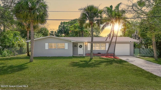 single story home with stucco siding, a front lawn, fence, concrete driveway, and an attached garage