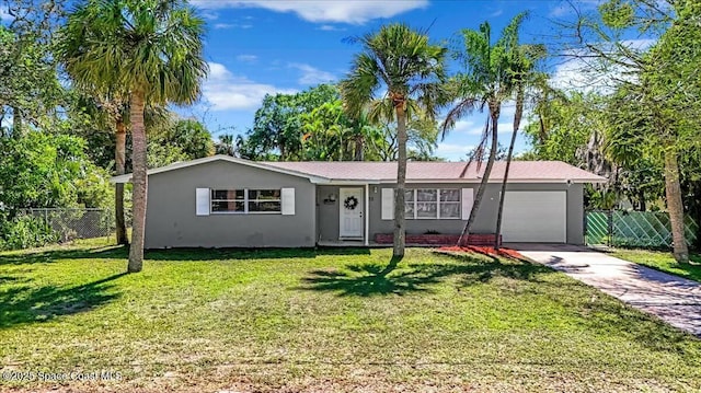 single story home with stucco siding, fence, concrete driveway, a front yard, and an attached garage